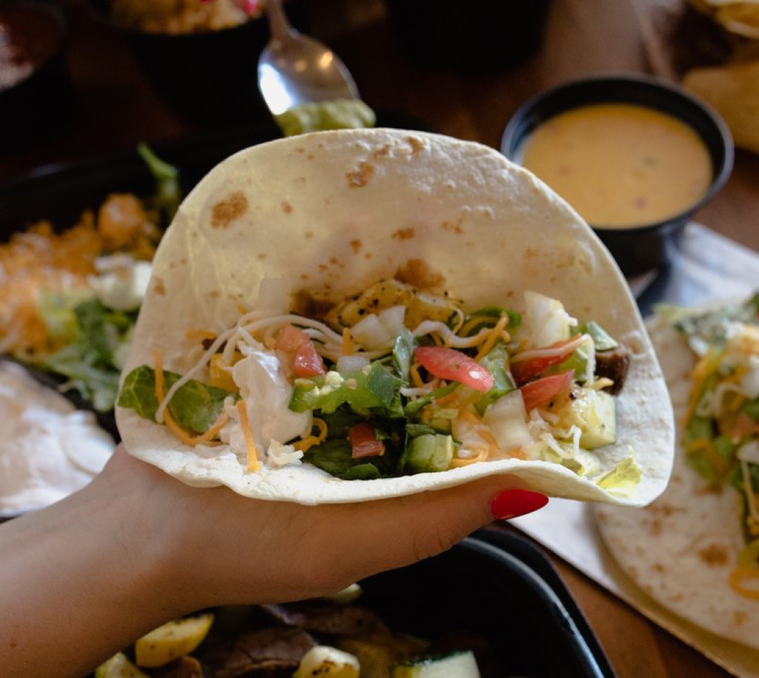 Flour tortilla being held by guest at Abuelo's