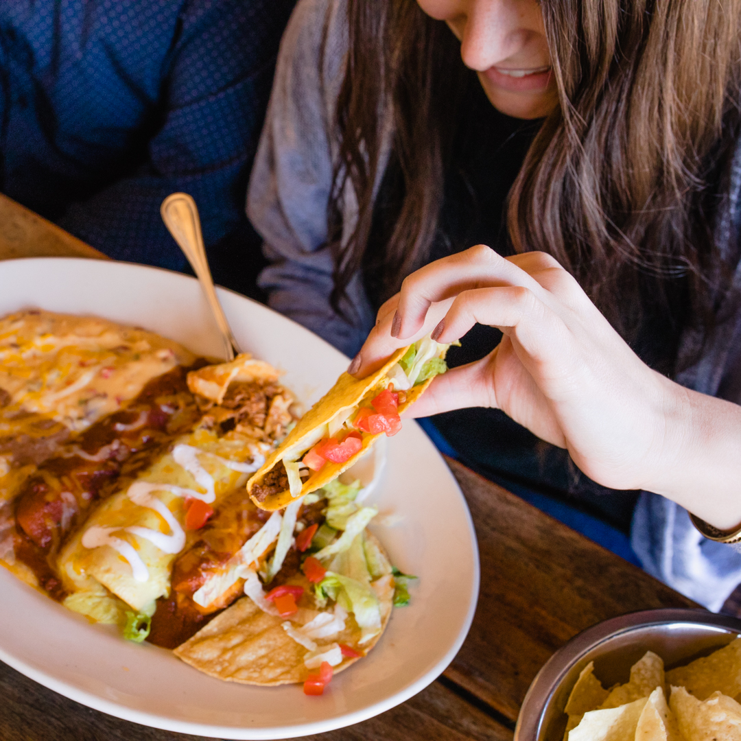 Guest holding a taco at Abuelo's